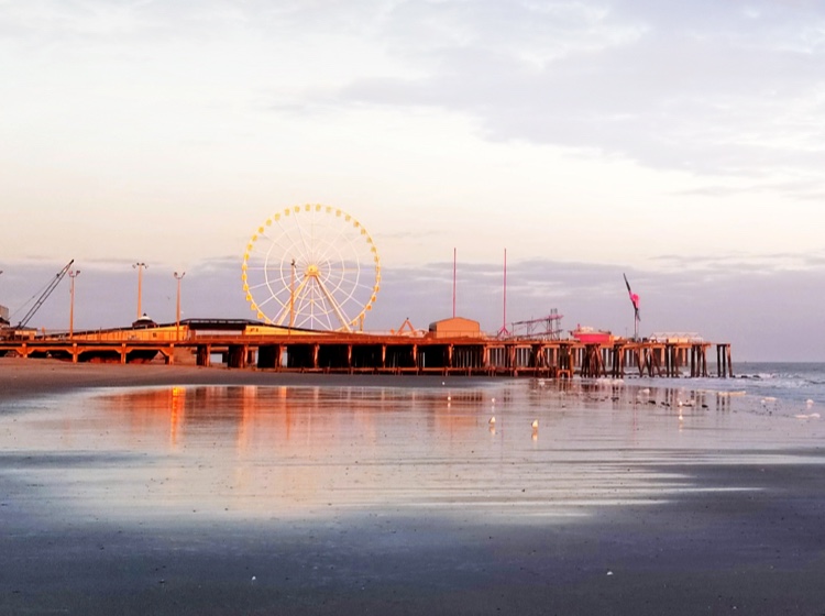 New Jersey boardwalk and ferris wheel at sunset