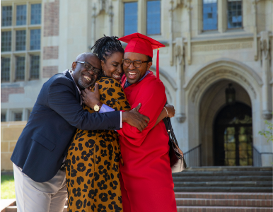 college graduate hugging his parents