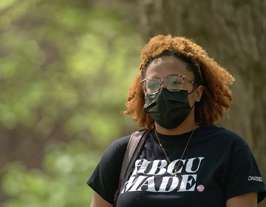 Woman walking with HBCU shirt on