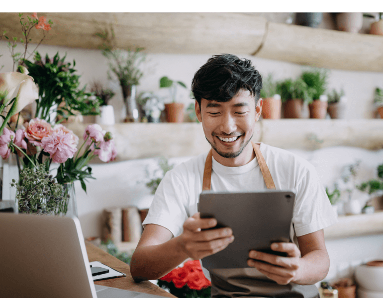 smiling man checking tablet