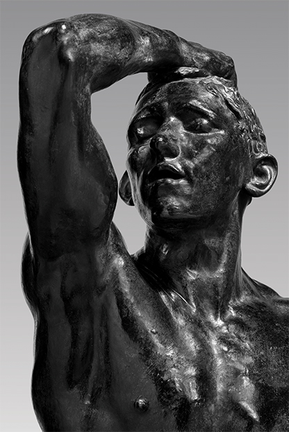 A statue of a person holding his head