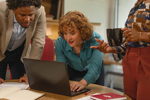 Person looking at screen with fellow employees