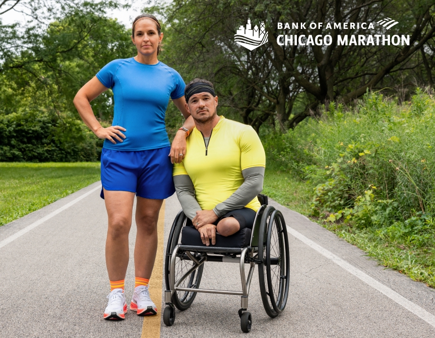 A man in a wheelchair and a woman posing on a road