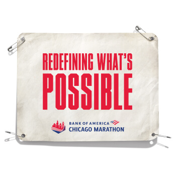 An image of a bib that says “Redefining what’s possible”
