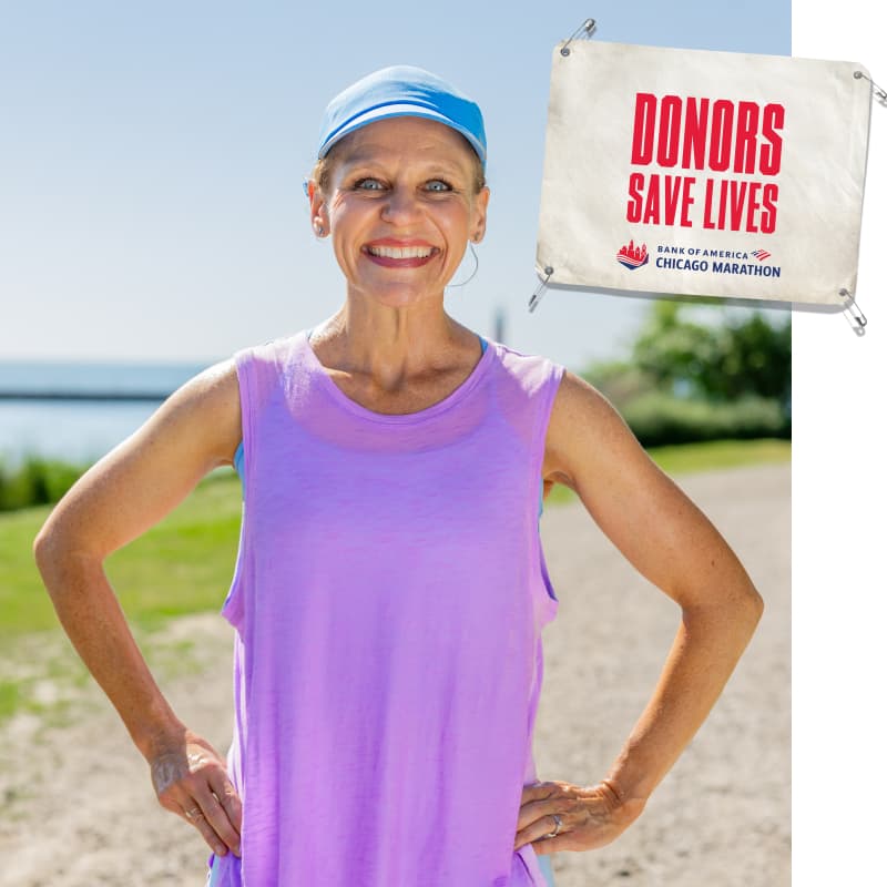 Christy standing facing camera with an image of a bib that reads “DONORS SAVE LIVES”