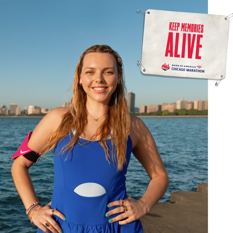 Leah standing outdoors with an image of a bib that reads “KEEP MEMORIES ALIVE”