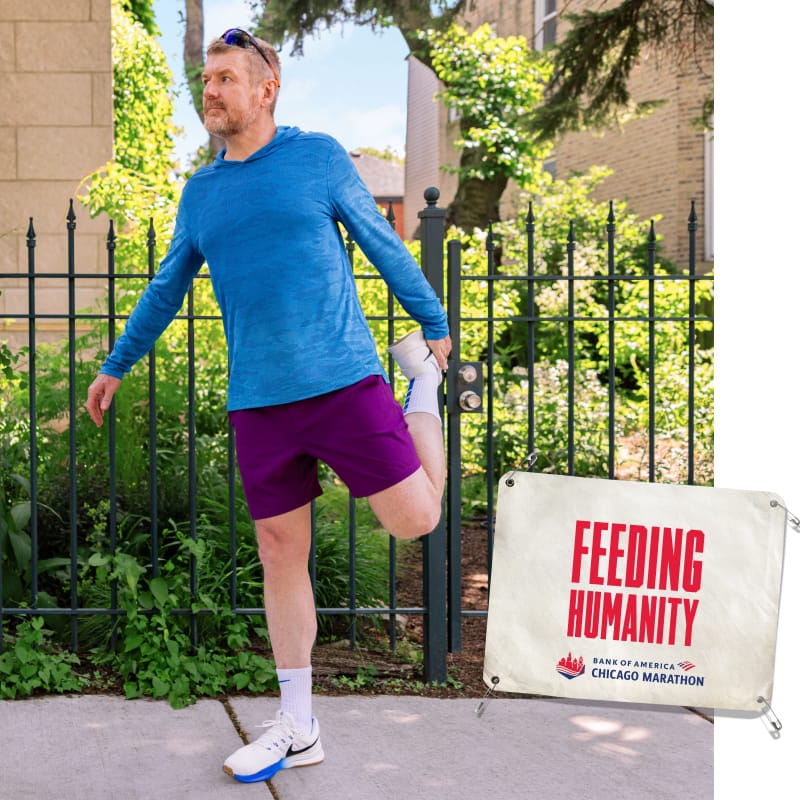 Nate stretching with an image of a bib that reads “FEEDING HUMANITY”