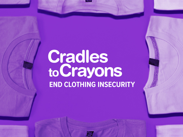 An Image of folded shirts with the Cradles to Crayons logo in the middle