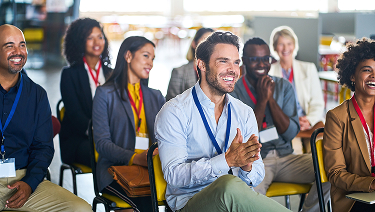 Group of workshop attendees sitting and smiling