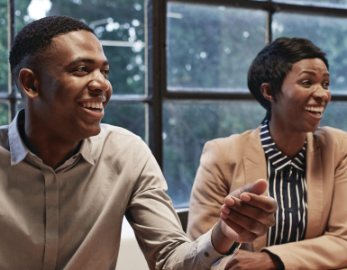 A man and woman smiling