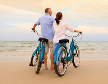 Couple with bikes on beach