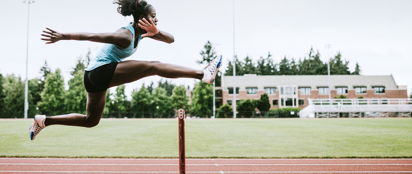 Runner jumping over a hurdle