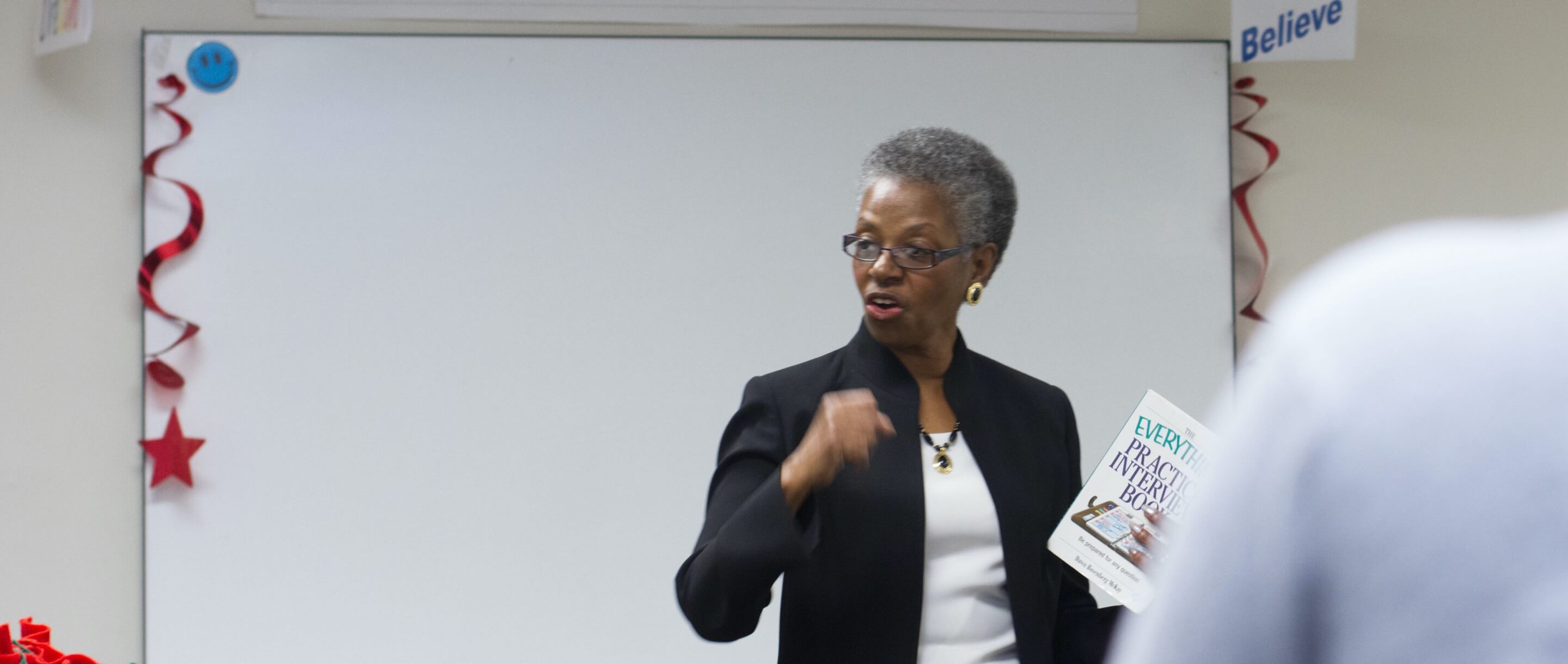 African American woman speaking to classroom