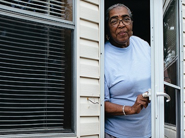 Elderly woman at front door