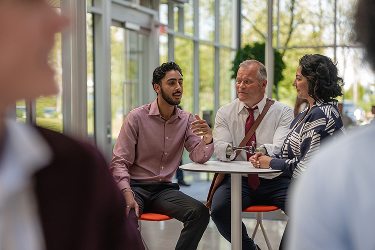 Two men and woman talking
