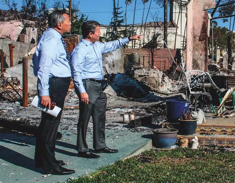 Photo of Raul Anaya of Bank of America surveying neighborhood damage from the LA wildfires