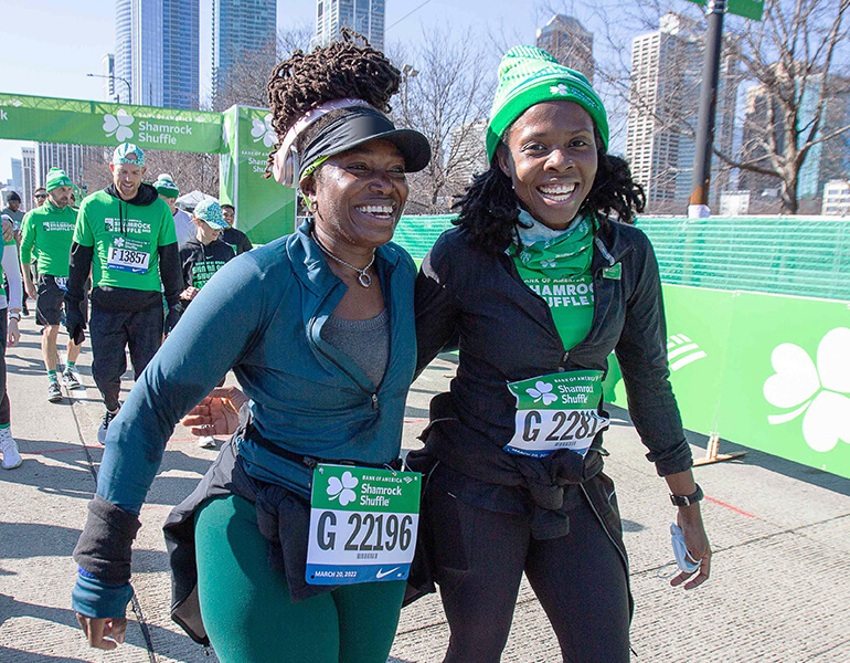 Two ladies smiling as they finish race
