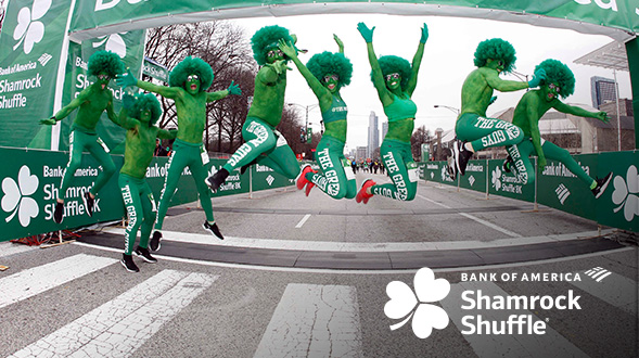  A group of Shamrock Shuffle runners in costume jumping into the air