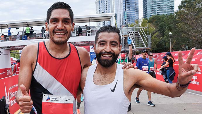 Two male runners smiling