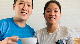 Coffee shop owners Tommy and Lisa Lau, with Tommy holding a cup of coffee