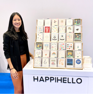 Woman standing by display of greeting cards