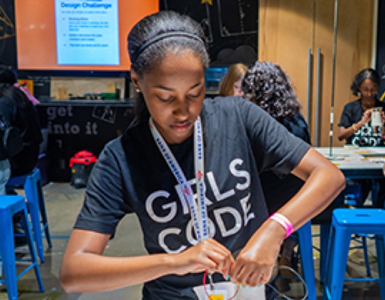 Girl wearing girls code shirt