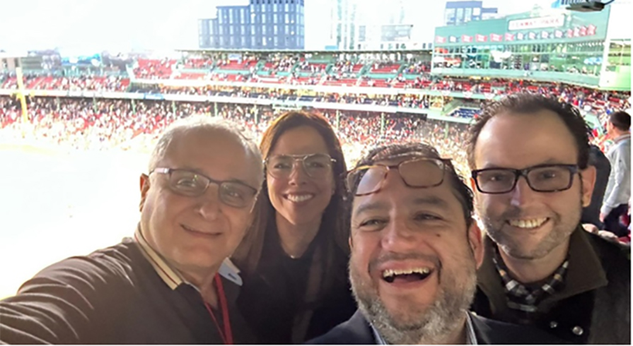 Selfie of four people with Fenway park in the background.