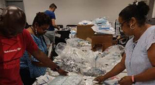 Volunteers pack boxes