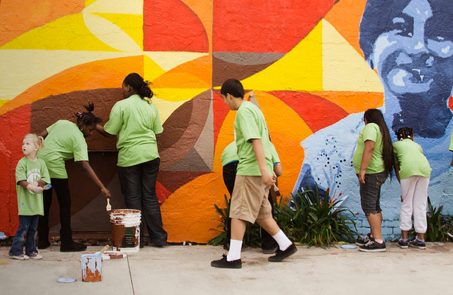 volunteers painting a mural