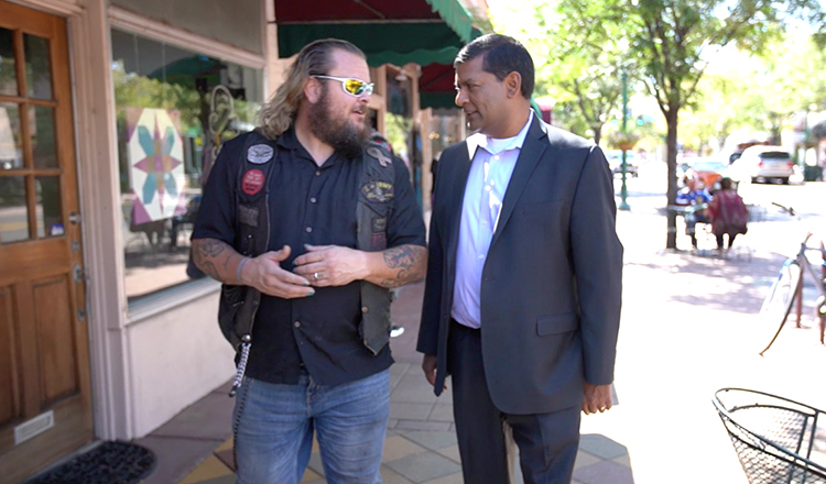 Two men walking and talking