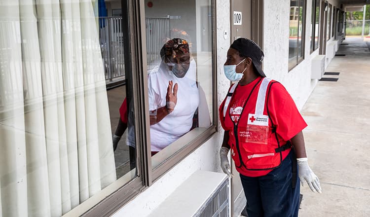 red cross employee looking through window