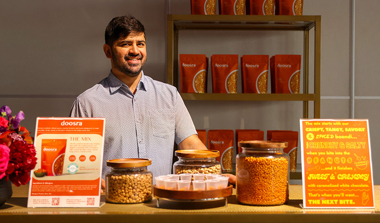 Kartik Das, small business owner of Doosra, displaying samples of his treats.