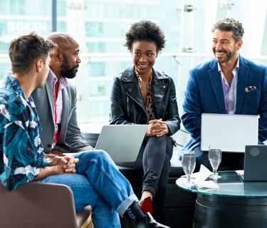 Group of diverse business people sitting next to each other