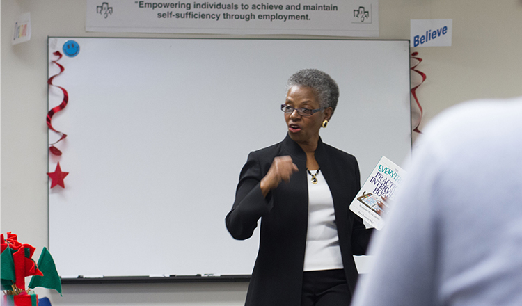 African American woman speaking to classroom