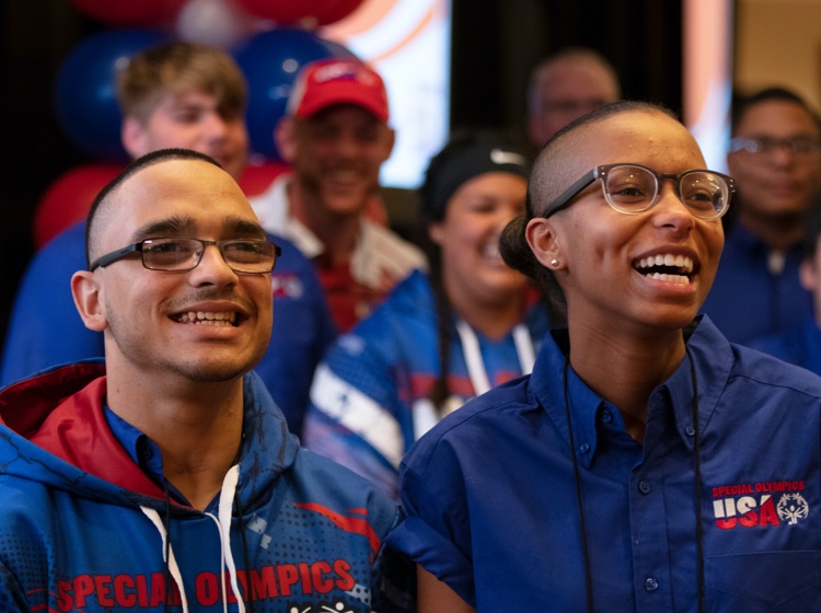 Two Special Olympics participants smiling at an athletic event
