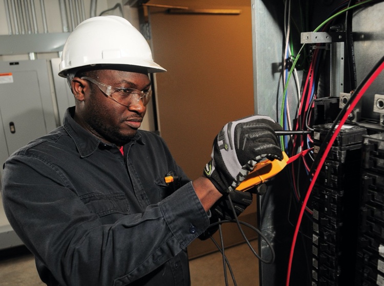 Employee working with technical and electrical components.