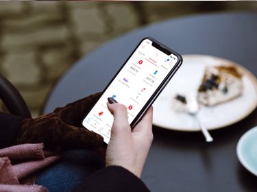 Person using their phone at a café outdoors