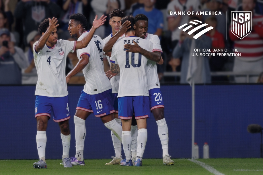 Professional soccer players hugging and celebrating on the field