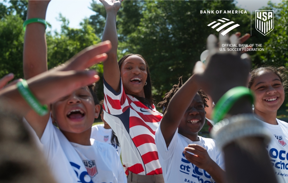 Crystal Dunn celebrating with Soccer at Schools kids
