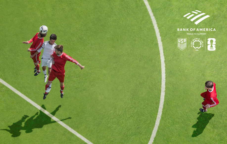 Soccer players competing for a head ball in front of a goal Logos for Bank of America, the U.S. Soccer Federation, and FIFA World Cup 2026 