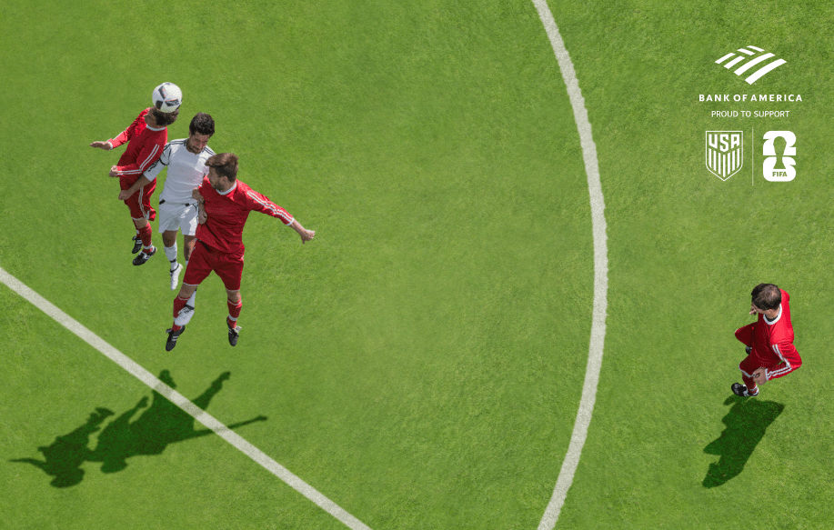 Soccer players competing for a head ball in front of a goal Logos for Bank of America, the U.S. Soccer Federation, and FIFA World Cup 2026