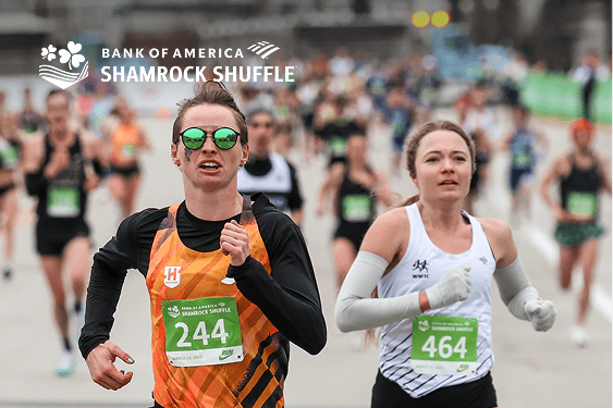 Two athletes side by side running in the Shamrock Shuffle