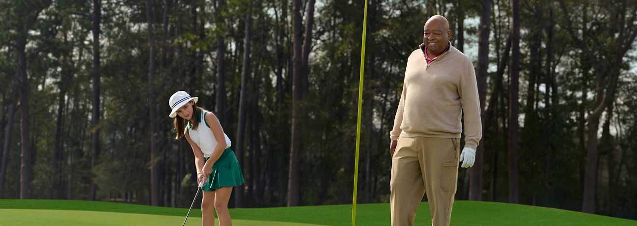 Ira Miller standing to the right of a young golfer, putting a golf ball