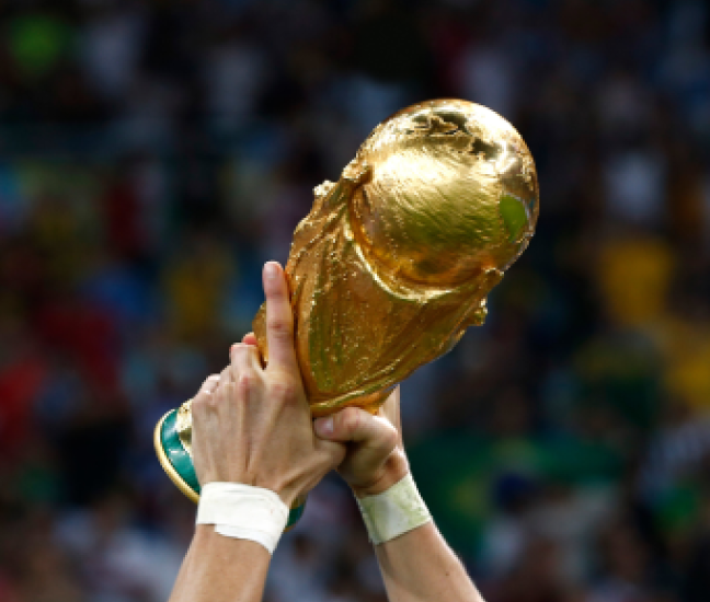 Hands raising the World Cup trophy in victory