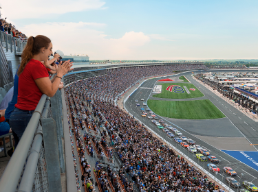 Fans watching a race from the grandstands.
