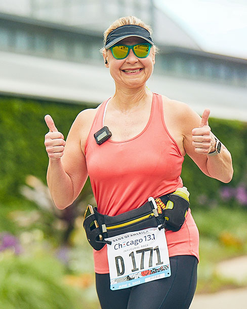 Woman running with two thumbs up