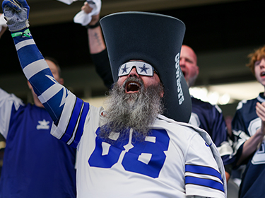 Cowboys fan cheering in stands