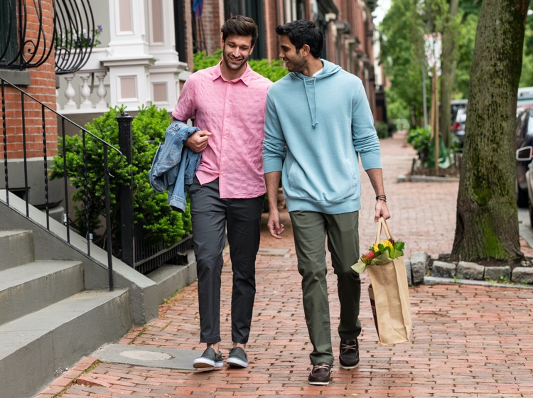 Two men walking holding hands