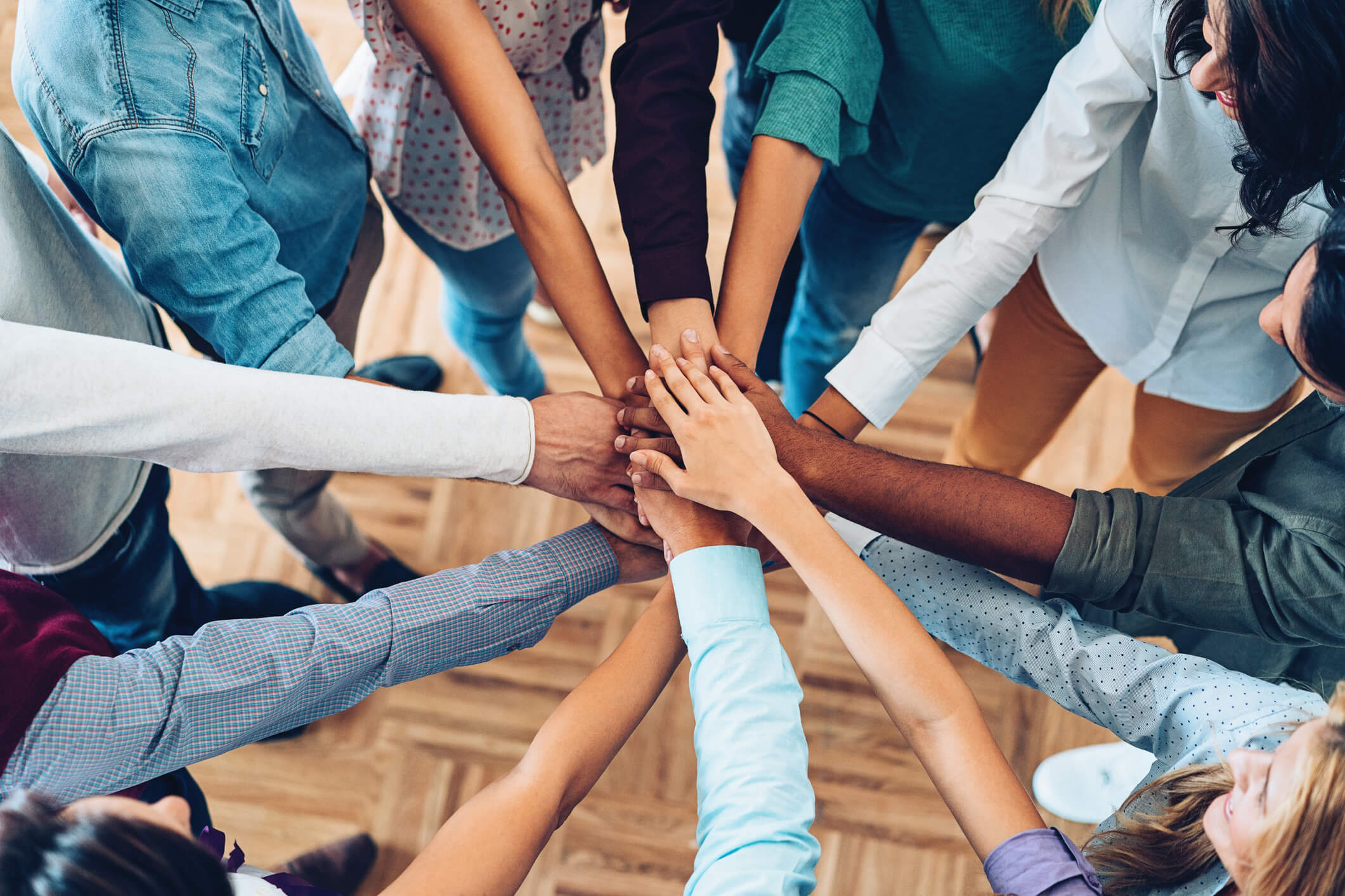 Group of people putting their hands together