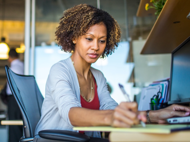 Woman writing at desk